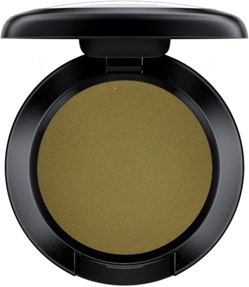 A round makeup compact with a black case and yellowish-green pressed powder inside.