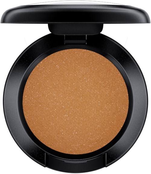 A round compact with a tan shimmery powder inside, open lid showing product.
