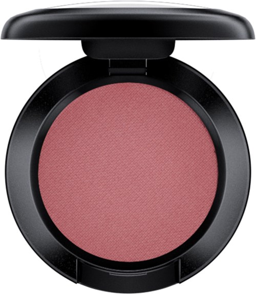 A pink blush in a black round compact with a lid. The blush has a textured surface.
