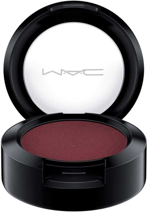 A round makeup container with a mirror open, showing dark reddish eyeshadow inside.