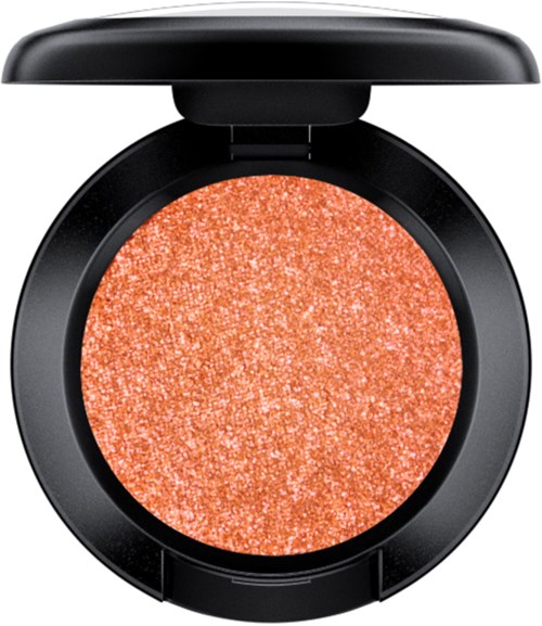 A sparkly coral-colored blush in a black compact with a lid.