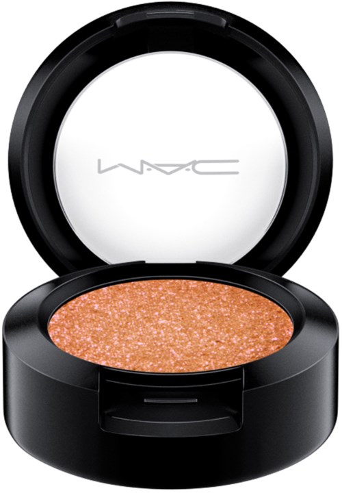 A makeup compact with a glittery, orange eyeshadow inside, and the MAC logo on the inside of the lid.