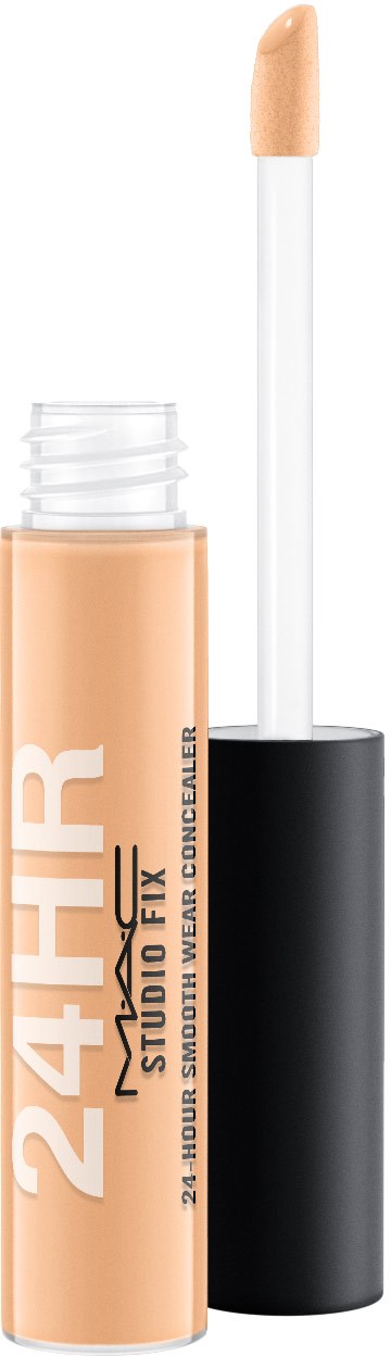 En beige concealer-sticka med svart lock och en vit borste.