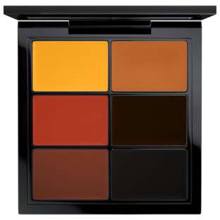 A makeup palette with six rectangular color sections, including yellow, brown, red, and black shades.