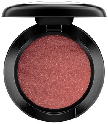 A round makeup blush in a black compact with a pinkish-red shade and slight shimmer.