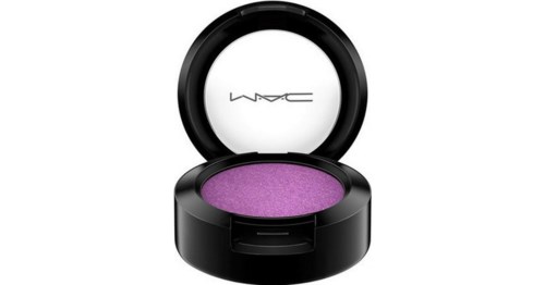 A black compact with purple eyeshadow inside, and the MAC logo on the transparent lid.