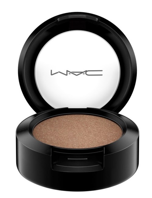 A small round container with a mirror, holding beige-colored makeup or eyeshadow.