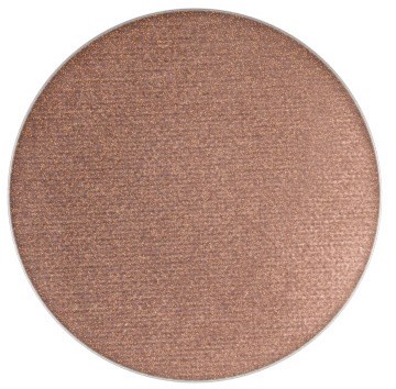 A round makeup blush with a shimmery, light brown color.