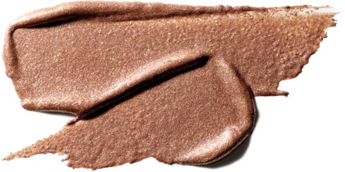 A smear of shimmery brown makeup or cosmetic cream with a smooth texture and shiny finish.
