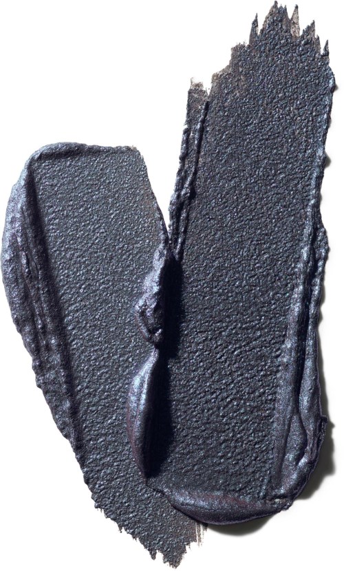 A broken black heart-shaped object with rough edges and textured surface.