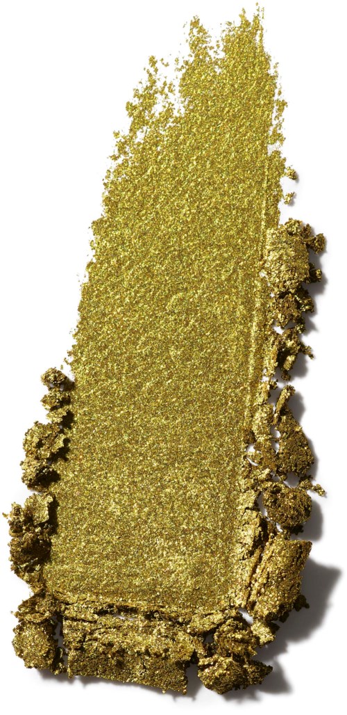 Ein rechteckiger Goldbarren mit rauen Kanten und glänzender Oberfläche, teilweise bedeckt mit kleinen Goldpartikeln.