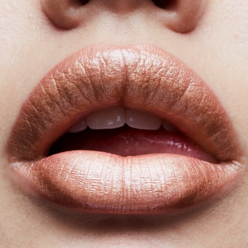 Close-up of lips with shiny, light-colored lipstick and partly open mouth, showing teeth.
