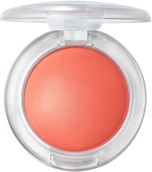 Coral-orange blush in a round compact with a clear lid. The makeup is smooth and shiny.
