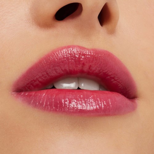 Close-up of lips with pink lipstick and white teeth, and the nose area above.