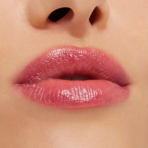 Close-up of lips and a nose, showing shiny, pink lips and smooth skin.