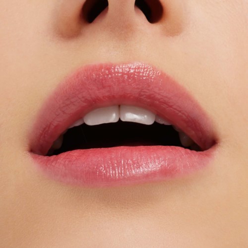Close-up of slightly parted lips with shiny, pink lipstick and visible white teeth.