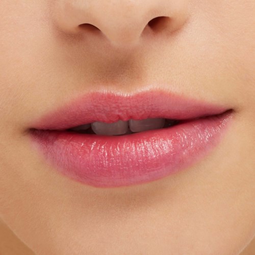 Close-up of lips slightly parted, showing upper teeth, with smooth skin around the mouth.
