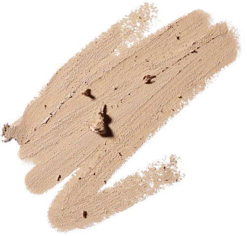 Lys beige foundationprøve med noen mørkere flekker på hvit bakgrunn.