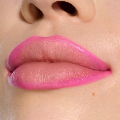 Close-up of lips with pink lipstick, showing smooth skin and natural lip shape.