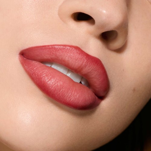 Close-up of lips with red lipstick, slightly open showing teeth and part of the nose.