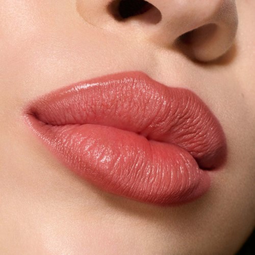 Close-up of full, pink lips with smooth skin around the nose.