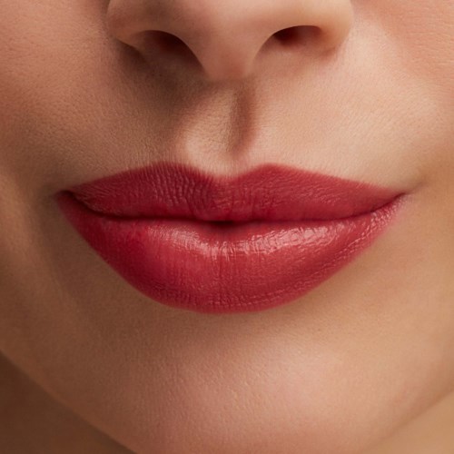 Close-up of lips with red lipstick and smooth skin around the mouth.