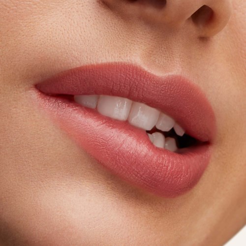 A smear of pinkish lipstick or paint on a white background. It appears glossy and smooth.