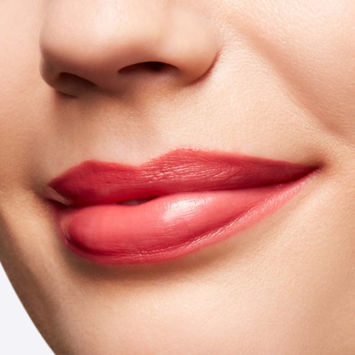 Close-up of a person’s lips with red lipstick, showing a slight smile.
