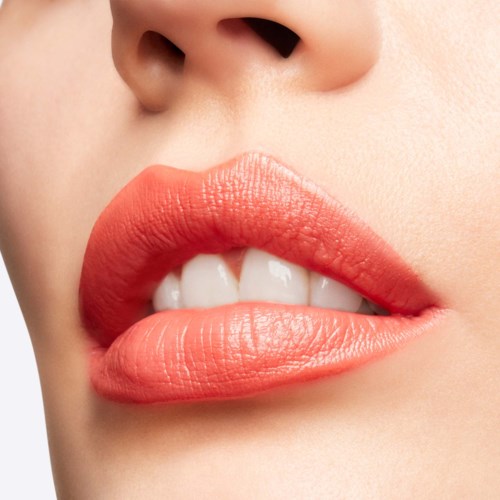 Close-up of lips slightly parted, showing teeth, with smooth skin and natural lip color.