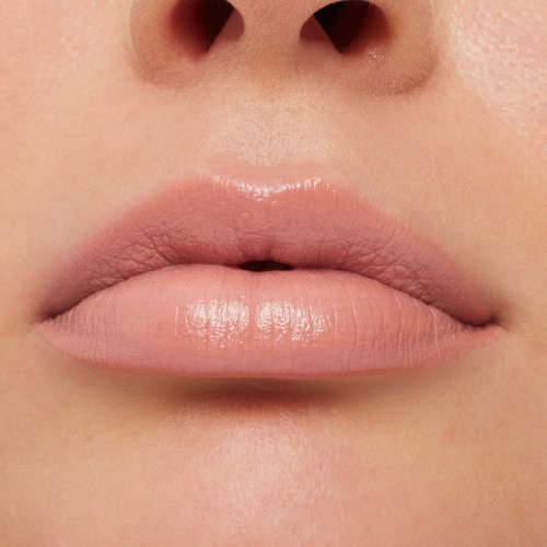 Close-up of lips and nose, with smooth, natural skin tone and soft lighting.