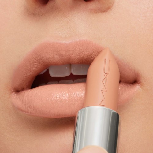 Close-up of lips with a MAC lipstick near the lip line, showing a soft pink color.