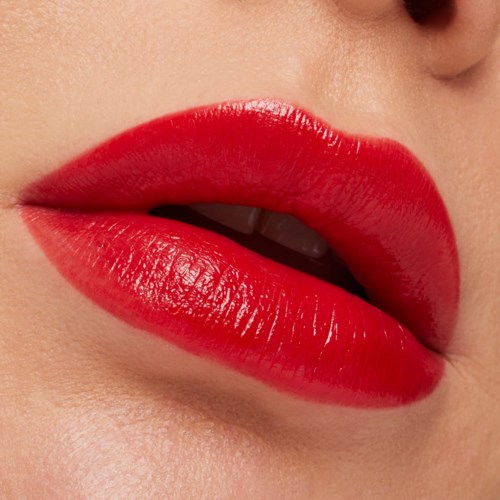 Close-up of lips with bright red lipstick, slightly parted showing teeth.