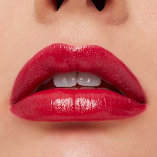 Close-up of lips with bright red lipstick, slightly parted revealing white teeth.