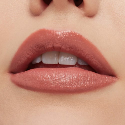 Close-up of lips with light pink lipstick and slightly parted. Small gap showing teeth. Soft skin around lips.