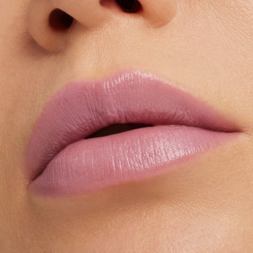 Close-up of lips with pink lipstick and smooth skin, showing part of the nose.