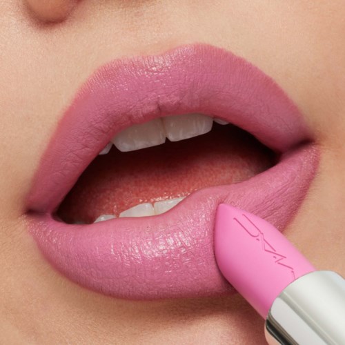 Close-up of lips being colored with pink lipstick.