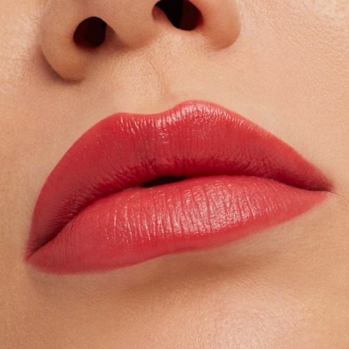 Close-up of lips with shiny, pink lipstick and skin with smooth texture.