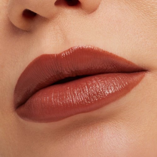 Close-up of lips with brown lipstick on smooth skin.
