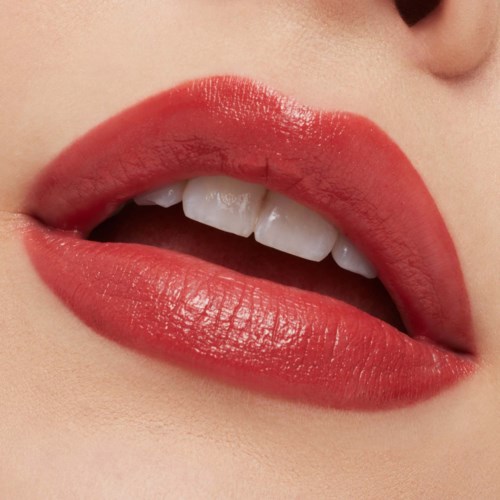 Close-up of lips with red lipstick, partially open showing white teeth.