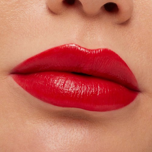Close-up of lips with bright red lipstick, smooth texture, slightly parted.
