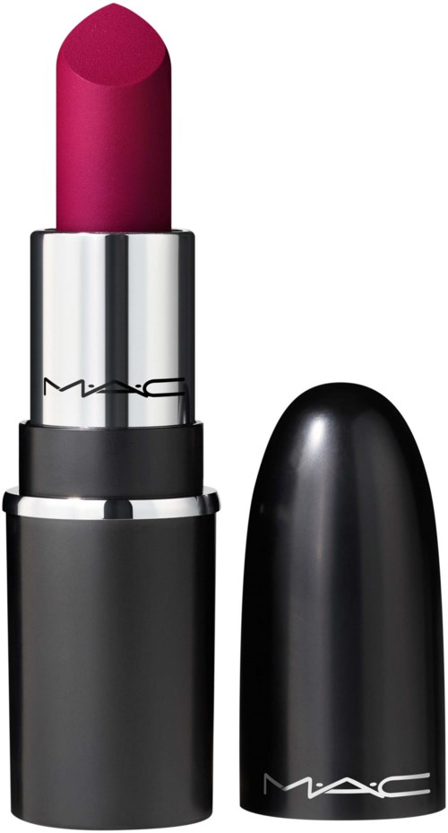 A bright pink lipstick in a silver and black container with a black cap beside it.