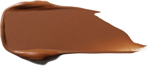 Eine glatte, braune, cremige Masse auf einer weißen Oberfläche mit dickeren Rändern.