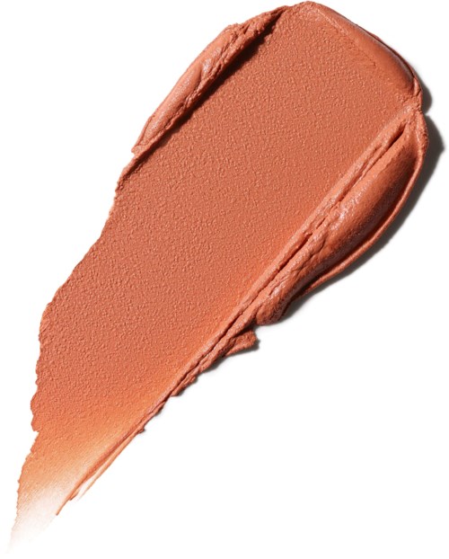 A brush stroke of peach-colored makeup or cream with a smooth, creamy texture.
