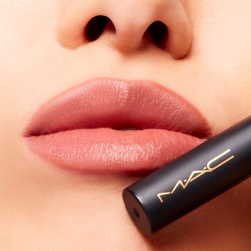 Close-up of lips and nose with a MAC lipstick stick near lips.