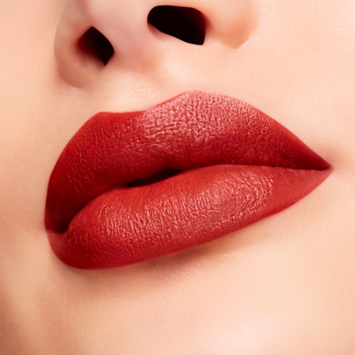 Close-up of lips with bold red lipstick and smooth skin around the nose area.