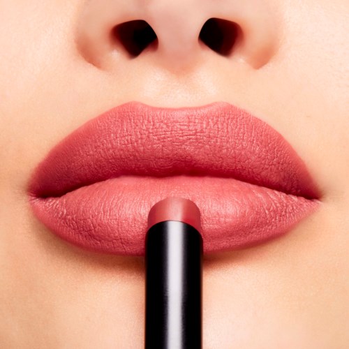 Close-up of lips with lipstick being applied, showing skin around nose and lip details.
