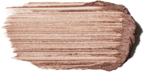 Lyst beige øyeskyggeskakke med skimrende effekt, synlige striper og teksturert kanter.