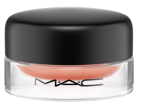 A small round jar with a black lid, labeled MAC, likely containing makeup or cream.