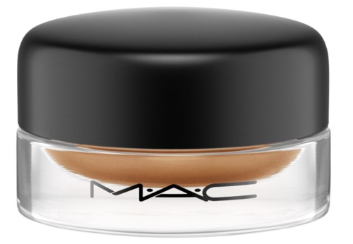 A small clear jar with a black lid and the MAC logo, containing beige cream or foundation.