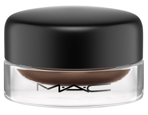 A small, clear container with a black lid, containing brown makeup or cosmetic product. The MAC logo is on the container.